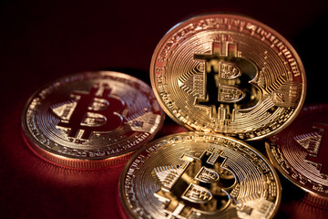 Photo Golden Bitcoins On Red Background. Trading Concept Of Crypto Currency