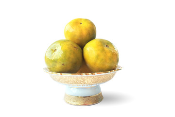 Oranges on ceramic respect tray, for the ceremony, fresh fruit, isolated on white background.