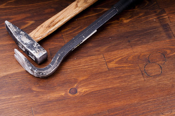 Hammer and nail puller on a table. Old tools