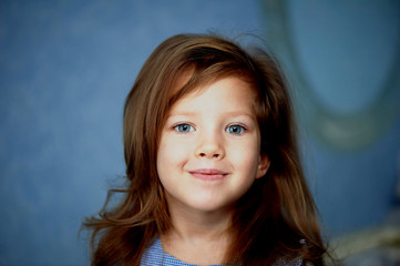 beautiful little girl with blue eyes and lush hair
