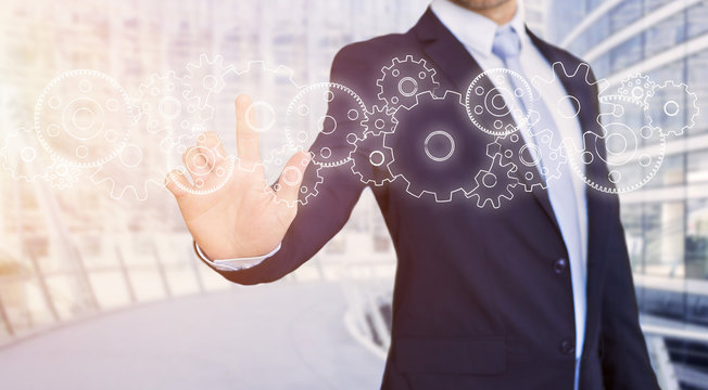 Businessman touching technology interface with gear wheel settin