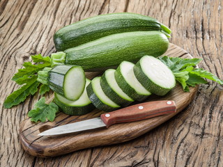 Zucchini with slices on a wooden table.