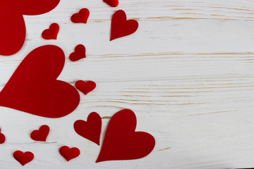 red hearts on a white wooden table. Valentine day.