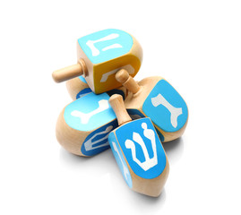 Wooden dreidels for Hanukkah on white background