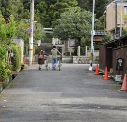 Rear view of tourists with bikes in Japan