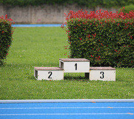 podium of an athletics stadium with numbers
