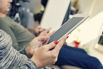 man and woman using electronic devices