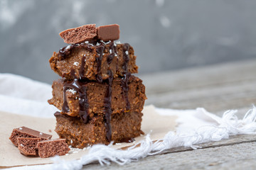 Chocolate pumpkin brownies with slices of chocolate and syrup. Love for a healthy desserts concept.