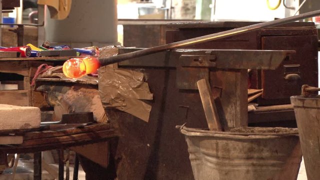 Murano glass being rolled in Venice, Italy