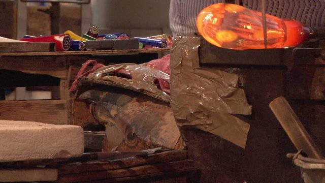 Murano glass being moulded by an artisan in Venice, Italy