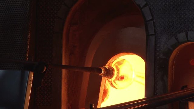 Murano glass being moulded in a furnace in Venice, Italy