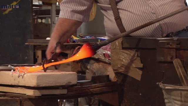 Murano glass being moulded by an artisan in Venice, Italy