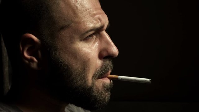 thoughtful man smokes a cigarette