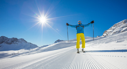 Skier on piste in sunny day. Skiing concept.