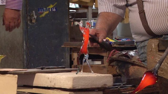 Murano glass being moulded by an artisan in Venice, Italy