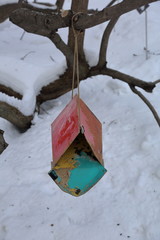Birdhouse-feeder in the snowbound winter city park