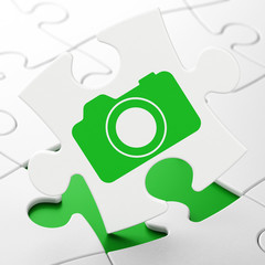 Vacation concept: Photo Camera on puzzle background