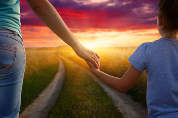 Hands of holding each other in field