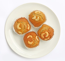 Banana cupcake with cashew nut on dish isolated on white background