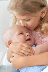 Obraz na płótnie Canvas girl with her newborn sister, close up