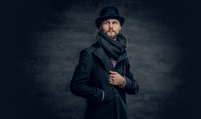 A man wearing jacket and cylinder hat.