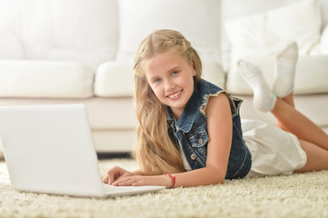cute little girl using laptop
