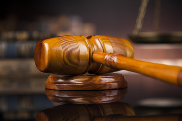 Law theme, mallet of the judge, wooden desk, books