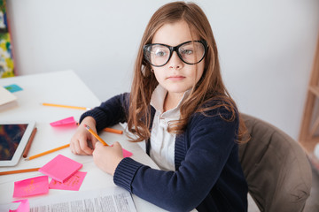 Little girl working in office like businesswoman
