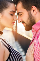 Naklejka premium Couple is touching foreheads. Woman's hand on man's chest. Nothing can break us apart.