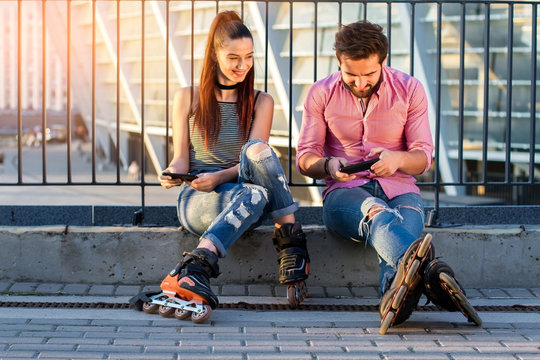Couple with cell phones. People on rollerblades sitting. Prank your boyfriend.
