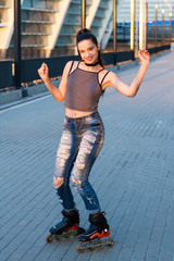 Woman smiling and rollerblading. Cheerful girl on urban background. Watch me roll.