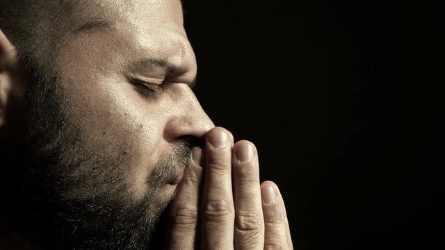 Profile of a young man praying