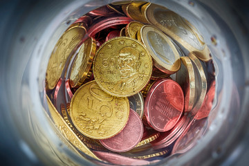 Euro coins in bottle and shadow as business, money, banking, currency and exchange rate  concept