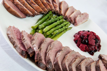 Meat with asparagus and berry sauce