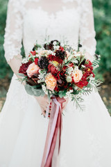 Beauty wedding bouquet in bride's hands