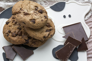 Sweet cookies with dark chocolate on the white mat