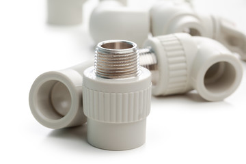 Set of metal-plastic plumbing couplings, adapters, plugs isolated on white background