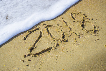 Abstract 2018 on a beach sand background