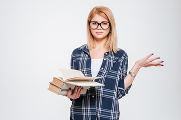 Confused young lady reading books