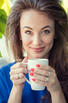 Woman drinking a cup of coffe in a cafe