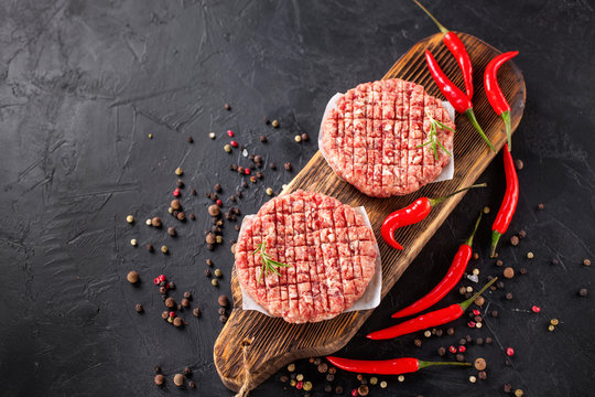 cutlets for hamburgers and spice on a board, selective focus, the top view, copy space