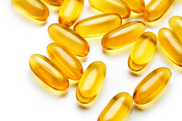 Close up heap of capsules Omega 3 on white background. Top view, high resolution product. Health care concept