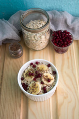 oatmeal with fresh banana slices, cranberries and flax seed