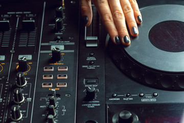 DJ playing music at mixer closeup