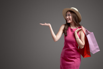 Young asian girl with hat holding shopping bags