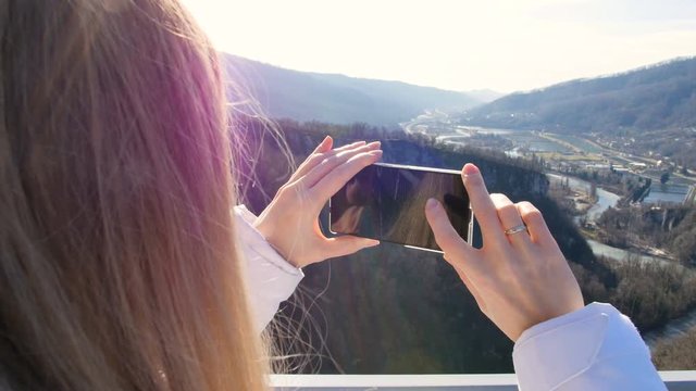 Woman take photos of the scenery nature views on the skybridge over the canyon