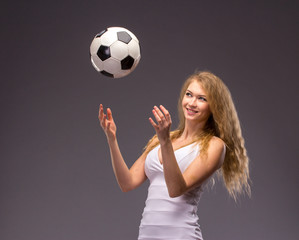 Young Woman In White Evening Dress with soccer ball