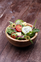 Caprese. Caprese salad. Italian salad. Mediterranean salad. Italian cuisine. Mediterranean cuisine. Tomato mozzarella basil leaves black olives and olive oil on wooden table. Recipe - Ingredients