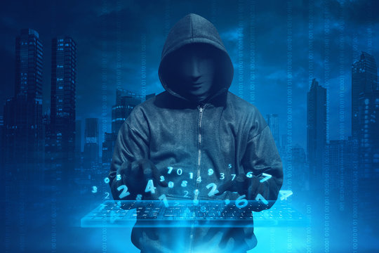Hooded man with anonymous mask hacking system online security