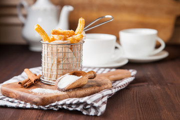 Spanish dessert: churros and tea on the table. Selective focus. Copy space.